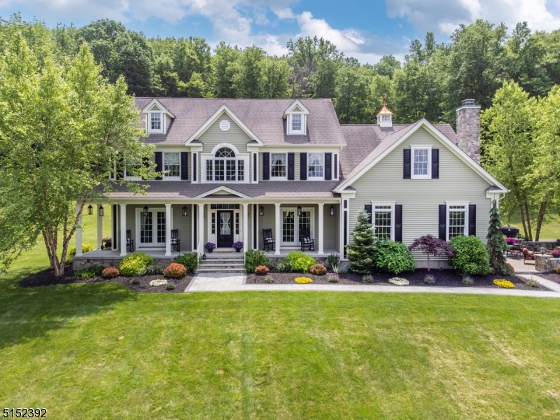 Incredible setting with one of a kind views!  Gallagher colonial is set on the hill, overlooking Warren Hills, sunsets and the beautiful scenery northern NJ is known for.  Approximately 30 woodland managed acres, ready for harvesting ($10,000+ income/cut) is a major tax savings for this slice of real estate heaven in Washington Twp.  The home itself has signature rounded corners throughout the interior, open floor plan, huge trophy room/great room formerly a garage, family room with woodburning fireplace, hardwood floors, fantastically functional mudroom/laundry/locker room, granite kitchen and formal living and dining rooms, each with French doors to the wraparound  rocking chair front porch with views. Four spacious bedrooms, including primary suite with tray ceiling and sitting area.  Unfinished basement has very tall ceilings.  Exterior is fieldstone and vinyl, features gorgeous paver patio and overlooks rolling hills and nature.  See survey for possible placement of pool and garage/barn, shed could become garage.  Access to hiking trail to Point Mountain right on property, minutes to Hackettstown and all of the fantastic dining options it offers, as well as shopping and theaters, Centenary College. Port Murray mailing address 07865. ACRES: 1.5+28.31 FARM.