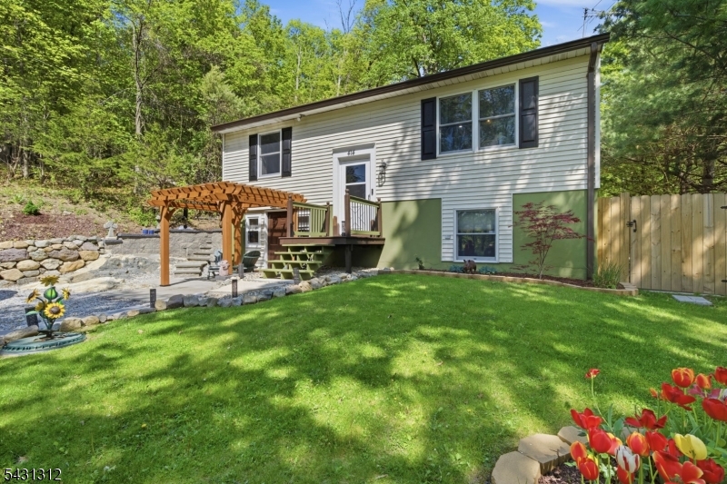 Beautifully renovated and move-in ready, this exceptional bi-level sits on a picturesque 1.1-acre property in desirable Lower West Milford. Offering the perfect blend of privacy, modern updates, and convenience, this home is ideal for today's lifestyle. The sun-filled main level features a spacious living room and an updated eat-in kitchen with quartz countertops, stainless steel appliances, and ample cabinet space. Two generously sized bedrooms and a full bath complete the upper level. The ground level offers outstanding flexibility with a large third bedroom, recreation/media room, half bath, and laundry area perfect for guests, a home office, gym, or additional living space. Step outside and enjoy over an acre of property surrounded by natural beauty, providing plenty of room for entertaining, gardening, recreation, or simply relaxing in your own private retreat. Additional features include central air, forced hot air heat, vinyl siding, septic, well water, and numerous recent updates. Conveniently located near shopping, dining, major commuter routes, parks, lakes, and year-round outdoor recreation. A rare opportunity to own a beautifully updated home with space, privacy, and a sought-after Lower West Milford location. Just unpack and enjoy!