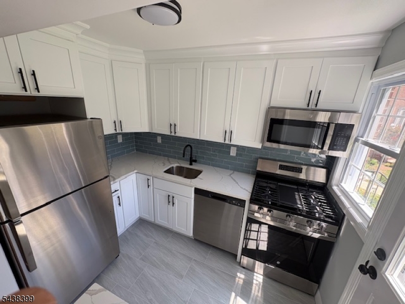 NEWLY RENOVATED WITH BRAND NEW KITCHEN , WITH QUARTZ COUNTERTOPS! NEW WINDOWS! NEW HARD WOOD FLOORS! NEW BATHROOM! FRESHLY PAINTED! COME INSIDE AND MAKE THIS YOUR HOME!