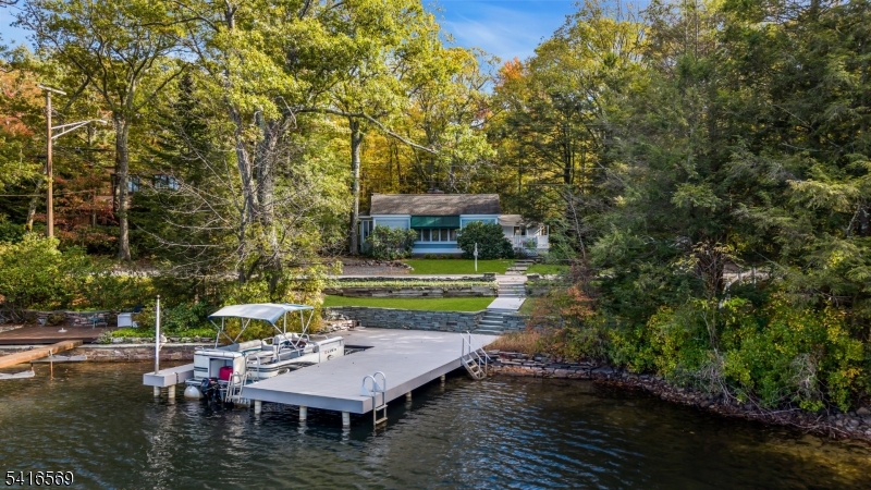 Located in Lake End Corporation, Green Pond 149 Lake End Road offers the rare opportunity to own a renovated, move-in-ready lakefront with a private year-round dock on New Jersey's cleanest lake.This 3-bedroom, 2-bath one level home features an open, easy-living layout anchored by stunning lake views and a  primary suite with sliders to a spacious deck overlooking the water. Thoughtfully designed for both comfort and style, the home includes two fireplaces, hardwood floors, central air conditioning, and a full-house generator, ensuring year-round enjoyment in all seasons.Additional features include a 2-car garage, a spacious lakeside deck ideal for entertaining, and direct access to your private dock perfect for boating, swimming and relaxing.Whether you're looking for a year-round home or the ultimate lakefront retreat, 149 Lake End Road delivers the best of lake life in an unparalleled setting.The community of Green Pond offers its residents private access to beaches, tennis courts, pickleball, an active Yacht Club with sailing, Community Club with events, and more. This golf cart friendly enclave provides a rare year-round vacation lifestyle surrounded by hundreds of acres of private woodlands, yet conveniently located minutes from major highways and just one hour from Manhattan.