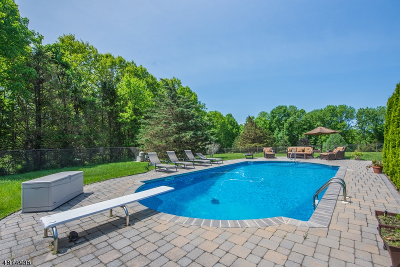Amazing Home Value!Beautiful 4300 sq foot brick front colonial with stunning curb  appeal set on almost 3 acres. In ground  heated pool built in 2012 is open and ready  for summer entertaining The first floor accommodates large crowds with a sweeping & open floor plan and a huge bonus room off the kitchen. Hard wood  floors on 1st and 2nd floors.2 story grand foyer.  2 fireplaces: wood burning in the family room-a gas in the formal LR. 1st fl bedroom/office w/adjoining full bathroom. Hard wood floors on the 1st and 2nd fls.  Natural gas, public water, multi zone heating and a/c. Great sunset views from the front of the house.  Freshly  painted deck with electric awning. 3 car garage and unfinished basement for storage.  Professionally landscaped.  Home warranty included.