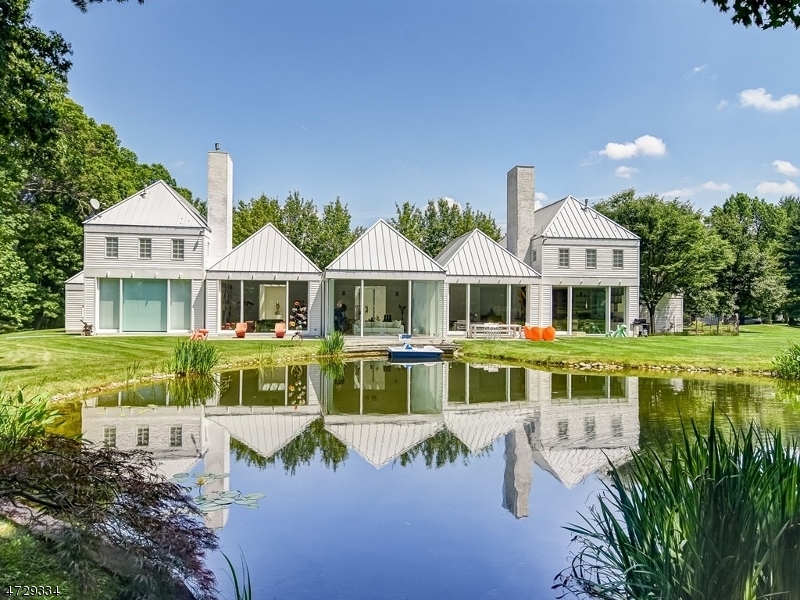 Unique Contemporary custom designed by prominent U.S. architect Hugh Newell Jacobsen widely known for his modern paviilion based residences composed of simple gabled rooms, rectangular in form. Truly a stunning departure from the ordinary, this showcase home is enhanced by uncommon attention to architectural detail and is spectacularly situated on a 2.6 acre lot  with a pond backing onto beautiful woods on the Harding/ New Vernon border. Entire back is glass bringing nature inside. Soaring light capturing pyramid ceilings. State of the art Chef's kitchen with white Poggenpohl cabinets,Granite counters and stainless appliances. First floor Master with his and hers spa like baths. 2 upstairs wings each with bedroom, bath and sitting room. 3 car garage enters on 1st floor. Maple floors.Chatham Schools!