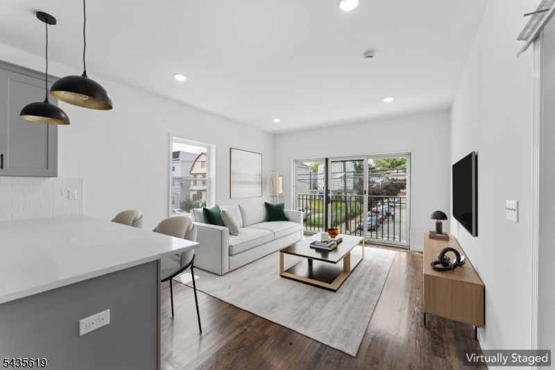 Brand new construction with a private garage and a rare ground-floor bonus living space, this kind of square footage simply doesn't come up often in Newark. Step inside to an oversized studio space with its own bathroom and private entrance. Direct interior access to your private garage. Upstairs, you'll find three generous bedrooms and two full bathrooms, all finished with brand-new fixtures and flooring. In-unit washer and dryer included. Shared backyard for grilling, gardening, or unwinding outdoors. Easy access to major highways, minutes from Weequahic Park, and a short drive to Newark Liberty International Airport. Every surface is brand new. Every appliance is brand new. You're the first to call it home.