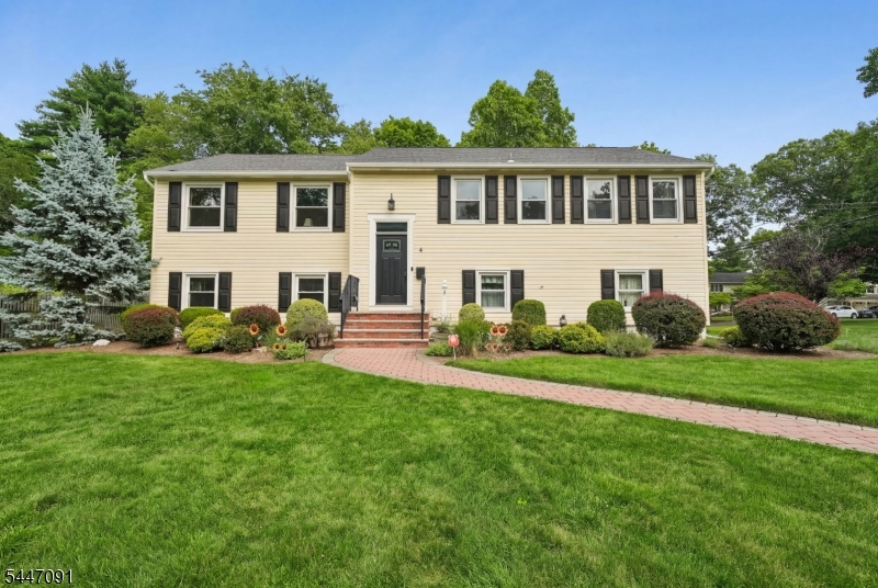 This beautifully updated, sun-filled 4-bedroom, 2 1/2 bath home offers the ultimate blend of versatile living and modern convenience. Gleaming wood floors, recessed lighting, a sleek eat-in kitchen (2018) features stainless steel appliances, soft close drawers, a barn door and premium countertops. Thoughtfully designed, this rare oversized bilevel home has a second staircase off the kitchen that leads to the lower level. All three entry ways (rear door, garage, foyer) are floored with imported Italian tile. The primary suite features a walk in closet and updated private bath. The expansive ground-level space is complete with family room displaying full wall built ins and shelving, guest suite/ fourth bedroom, laundry, bath and direct access to the oversized two car garage and backyard. Updates include newly paved driveway in 2019, new roof & insulated all weather front door in 2020, front steps w/ maintenance free aluminum railings & paver walkway 2016, windows 2015, hot water heater in 2023, new electric panel 2017. Professionally landscaped with outdoor lighting. Located just minutes from Livingston's top-rated schools, NYC transit, houses of worship, parks and local shopping.