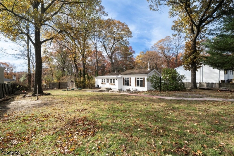 DISCOVER THIS CHARMING CABIN NESTLED ON A GENEROUS HALF-ACRE PROPERTY IN A QUIET CUL DE SAC LOCATION WITH A BRAND-NEW WELL being installed for you!!  Be prepared to fall in love with this super cute home featuring living/dining room, family room with cathedral ceilings, kitchen with white cabinets, primary bedroom boasting a walk-in closet, another bedroom, a tastefully updated bathroom, and a laundry room.  Large basement provides lots of storage space and workshop space if you need one.   Expansive yard is perfect for entertaining or private enjoyment.  Plenty of available parking spaces. The fireplace is not functional and being sold as is. This home is move-in ready and waiting for its new owners!