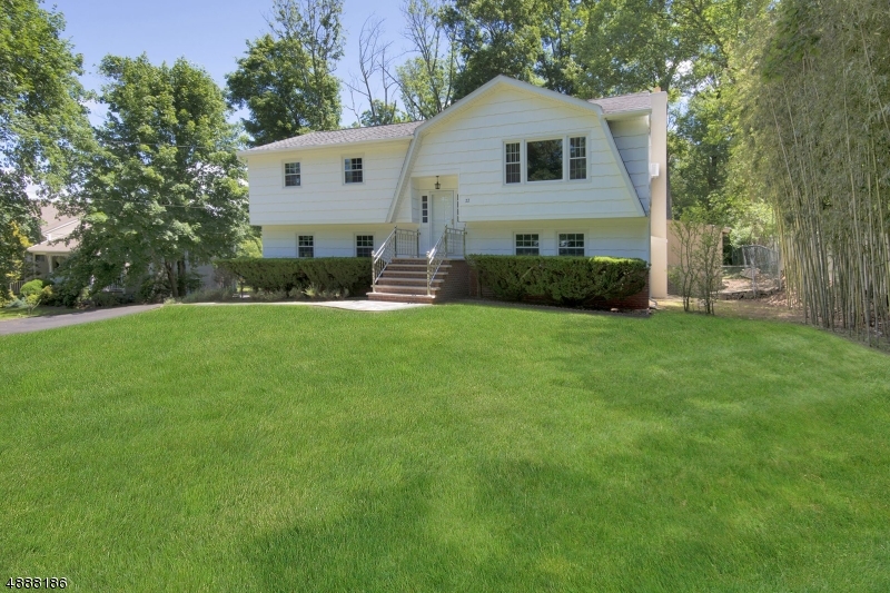 Few blocks from train station!!! What a great house!!!  Expanded 5 bedroom,  2.1 bath bright and airy bi-level looking for a new owner!! First floor features updated kitchen with granite counter tops, living room, dining room, master bedroom with full bath, three additional bedrooms and main bath.  Both bathrooms are newly updated!  All rooms are spacious and hardwood floors are throughout first floor.  Ground floor will impress you with family room featuring wood burning fire place that expands to sun room providing lots of natural light, additional bedroom, half bath.  Almost all windows have been replaced!!. Two car garage and flat large fenced in backyard complete the picture!  Welcome home!