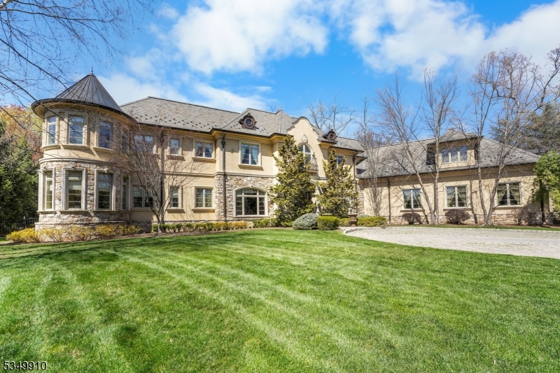 Welcome to luxurious living in the prestigious enclave of The Pond. Set on over 1 acre of beautifully landscaped property, this custom-built estate offers 7,300+  sq ft of refined elegance not including the vast lower level. Step inside to a grand open fl plan where vaulted ceilings, arched doorways, custom moldings & built-ins blend timeless charm w/ modern sophistication. Abundant natural light pours in through oversized windows, highlighting every exquisite detail. Heart of the home is a gourmet kitchen featuring high end appliances, a wood-burning fireplace, pizza oven, ample cabinetry & a large center island w/ seating. The butler's pantry connects to a formal dining room, ideal for entertaining. The great room stuns w/ ornate ceilings, gas fireplace & a custom wet bar, while add'l spaces incl a formal living room, library & custom wine room. A main fl bedroom w/ full bath, laundry room & powder room add convenience. Upstairs the primary suite is a true retreat w/ a gas fireplace, his & her walk-in closets & a luxurious spa bath featuring a jetted tub, walk-in shower & dual vanities. 3 add'l. bedrooms are en-suite w/ full bathrooms & walk-in closets, 2nd laundry rm adds functionality. LL incl spacious family rm, media rm, exercise rm & full bathroom, offering versatile space for entertainment & wellness. Step outside to enjoy the serene patio, outside bar area, pond w/ waterfall, pickle ball court. & lush grounds. A 3 car garage completes this extraordinary offering.