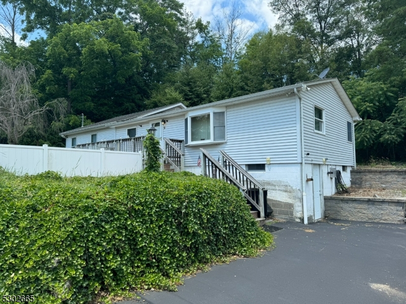 Spacious 3 bedroom ranch situated on a corner lot in Lake Neepaulin, Formal living room, kitchen with breakfast bar and separate dining area.  Large primary bedroom with walk in closet and unfinished space for a future full bath. Partial walkout basement with laundry and doggie wash station.