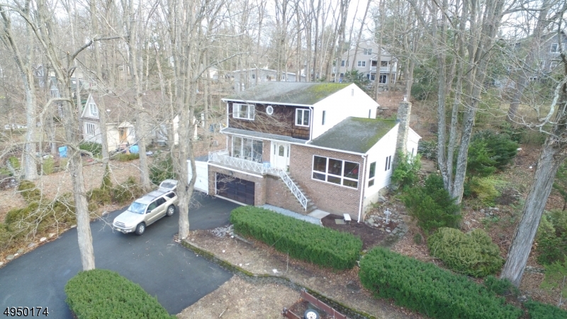 Put your updates & personal touches on this spacious Lakehouse.  Open floor plan is designed with walls of windows to capture the lake views.  Oversized Great Room with H/W floors offers stone fireplace as focal point.  EIK with island and serving bar.  Large formal Dining Room opens to Living Room with view of lake.  Ideal floor plan for entertaining.  2nd floor Bedrooms with great closet space.  Master bedroom offers bath.  So much character in the backyard with stone patio & fireplace.