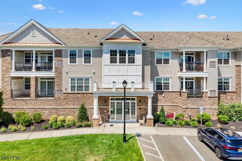 Luxury, lifestyle, and exceptional convenience come together in this beautifully appointed second floor residence at Enclave at Canal Walk, one of Central New Jersey's premier gated 55+ communities. Built in 2021, this rare offering includes two deeded garage parking spaces and a private 10 x 15 climate controlled storage room within the building, a combination seldom available within the community. Designed with an open, airy floor plan, this elegant home features soaring ceilings, abundant natural light, and upscale finishes throughout. The gourmet kitchen flows seamlessly into the spacious living and dining areas, creating the perfect setting for everyday living and entertaining. The generously sized primary suite offers a walk in closet and private bath, while a second bedroom and full bath provide comfortable accommodations for guests, or a home office. Enjoy maintenance free living with outstanding resort style amenities including a beautifully appointed clubhouse, indoor and outdoor pools, pickleball and tennis courts, a putting green, fitness center, walking trails, and a vibrant calendar of social activities. Ideally located near major highways, shopping, restaurants, and commuting routes, this exceptional home offers the perfect blend of luxury, comfort, and carefree living in one of the area's most sought after active adult communities.