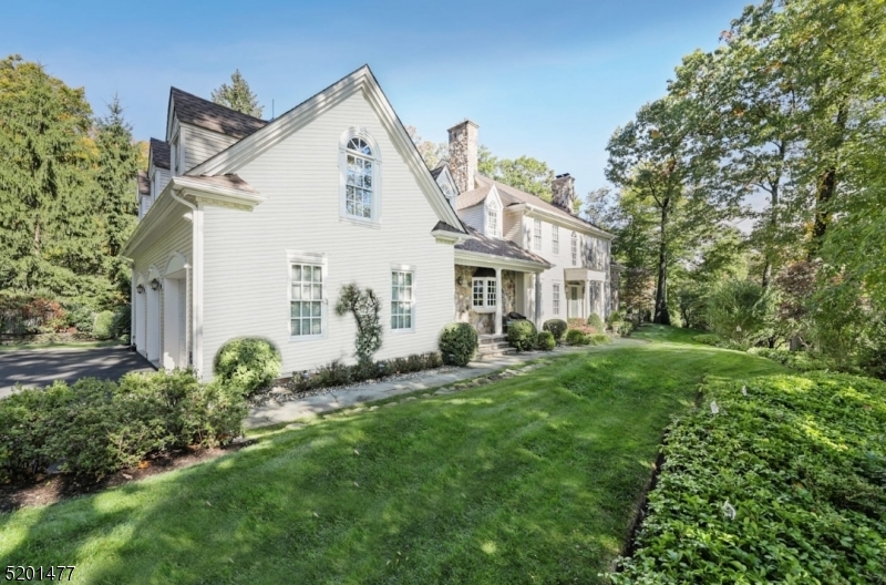 Truly spectacular Short Hills show stopper! Sensational fully renovated custom colonial with approximately 6670 square feet of living space including finished lower level. Heart of Short Hills location with extensive millwork throughout is situated on gorgeous property close to NYC trains & stellar schools. Exquisite designer finishes everywhere with perfect layout featuring an open floor plan, high ceilings, on-trend renovations + multiple indoor and outdoor entertaining spaces. Elegant Foyer with sweeping formal curved staircase sets the tone. Formal Living Room opens to Family room, Sunroom/Game Room & convenient 1st floor Library / Office with patio access. Chef's Kitchen with custom cabinetry, center island, granite counters, high-end stainless steel appliances leads to double-height Breakfast Room with access to covered porch & attached 3-car garage with electric charger. 2 powder rooms complete 1st level. Back stairs provide additional access to 2nd level sitting room and 5 bedrooms. Fabulous Primary Bedroom Suite includes fireplace, 3 walk-in closets, sitting area and luxe Primary Bathroom. Bedroom 2 is ensuite. Bedroom 4 and 5 provide an adjoining 3rd full bathroom. A 5th Bedroom and Laundry Room complete 2nd level. Recently renovated Lower Level Rec Room, Wine Room, Exercise Room + Art Studio / Office. Amazing property with meticulous landscaping, wraparound brick patios & built-in planters. Design and modern luxury are uniquely embodied in this special home!