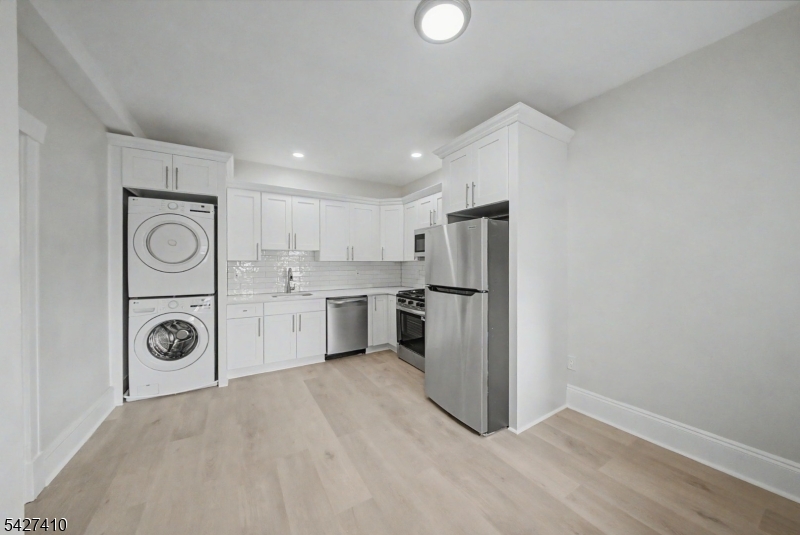 Renovated 2 bedroom apartment in an elevator building located in Boonton featuring a bright and updated interior with refinished wood flooring, neutral finishes, and spacious room sizes throughout. The remodeled eat in kitchen includes stainless steel appliances, white shaker cabinetry, subway tile backsplash, dishwasher, microwave, gas range, and in unit stackable washer and dryer. Large living room and bedrooms offer excellent natural light and generous closet space. Updated full bath with clean modern finishes. Located in a well maintained apartment building with public utilities, on street parking, and immediate occupancy available. Convenient access to downtown Boonton, shopping, dining, and major commuting routes.