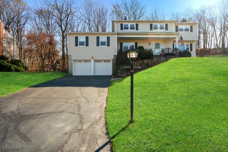 Enjoy the beauty of nature in this updated Colonial with four bedrooms & three bathrooms, offering a spacious haven nestled on .46 private acres in scenic Budd Lake, near fantastic lakes and trails, & convenient to shopping, restaurants & schools. This home feat. light & bright rooms, hardwood flrs, many upgrades, attached two-car garage & a large back deck. First floor feat. living room with inviting fireplace, large dining room with French doors to the deck, a den/office, powder room & huge family room that?s perfect for entertaining. The sunny remodeled kitchen includes granite counters, SS appliances, modern white cabinetry & a pantry. Upstairs, the master bedroom suite boasts a dressing/sitting room, walk-in closet & private bath. Three additional bedrooms each have walk-in closets & a full hall bath.
