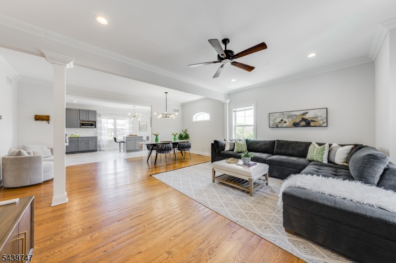 BOUTIQUE, NEWER BUILD CORNER UNIT TOWNHOME IDEALLY LOCATED IN THE HEART OF BERKELEY HEIGHTS. Close to everything"NYC Direct train, shops, restaurants, parks & top-ranked schools. Lovely stacked-stone/siding exterior. Bright & beautifully finished w/ crisp moldings, gleaming hardwood floors & large Windows throughout. Great layout w/ large rooms. Eat-in Chef's Kitchen spans width of unit & features shaker-style cabinetry, s/s appliances & designer tile. Open-concept Dining Room & Family Room are sized for big gatherings. Stylish Powder Bath has pedestal sink & wood-look tile flooring. Primary Bedroom Suite is true retreat w/ 2 Custom Walk-In Closets & gorgeous Full Bath w/ double sinks, luxurious standalone soaking tub, generous shower w/ pretty patterned tile. Hallway w/ convenient Laundry Closet leads to another En-Suite Bedroom w/ pretty Full Bath. Third Level Bedroom is huge & tranquil respite w/ charming French doors & plentiful natural light from Windows on 3 exposures. Adjacent Full Hall Bath boasts large frameless glass Shower, modern subway tile. On Lower Level find extra-large 1-Car Garage, wall of 3 double-door Storage Closets perfect for corralling coats, shoes & sports equipment. At the end of a long hallway, private Bonus Room w/ recessed lighting & LVP flooring could be your next Home Office, Exercise Room, or anything else! Sliding glass doors flood the space with natural light & open onto private Patio. 569 Springfield is townhome living at its best!