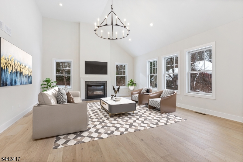 Introducing a stunning new construction home offering over 4,000 square feet of thoughtfully designed living space. This exceptional residence features 4 bedrooms and 3.5 baths, set on a 1.6 acre lot just minutes from downtown Chester.A dramatic two-story foyer welcomes you into an open, light-filled floor plan highlighted by soaring ceilings and elegant wide-plank hardwood floors throughout. The chef's kitchen is a true showpiece, featuring a large center island with Calacatta countertops and top-of-the-line BOSCH appliances. The space flows seamlessly into a sunlit eat-in area and an inviting family room with a cathedral ceiling and a cozy gas fireplace. Step out onto the deck off the kitchen perfect for outdoor dining and entertaining. Just off the foyer, a private study or home office with French doors provides an ideal work-from-home space. Upstairs, the expansive primary suite offers a walk-in closet and a spa-like bath with double vanities, a soaking tub, a stall shower, and elegant Calacatta countertops. Three additional bedrooms include one with an ensuite bath, along with a generous bonus room ideal for a game room, media space, or recreation area. Designer lighting from Chester Lighting enhances the home's sophisticated ambiance. Additional highlights include a heated three-car garage equipped with an electric vehicle charger. This exceptional property combines luxury, comfort, and modern convenience and is truly a must-see.