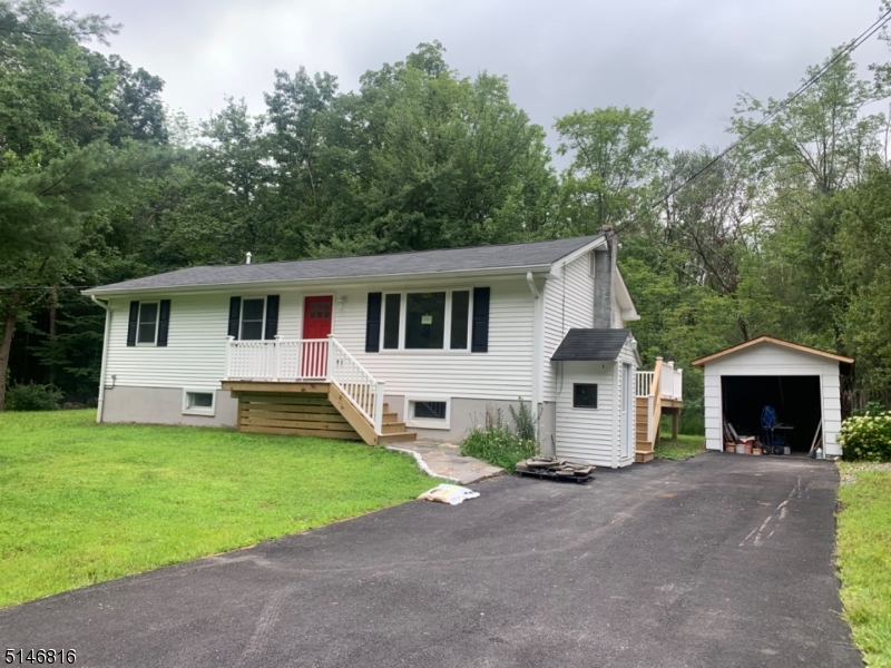 Completely remodeled from the studs up. Country living on over an acre in Crandon Lakes. Everything new including new walkway, painted front door, newer vinyl siding, gutters, a new roof, new windows, a new well head, new electrical, new plumbing, central AC, new sliding door, electric hot water heater, back deck , front porch and brand new septic! Kitchen has SS appliances with soft close cabinets, center island w/ butcher block top, new paved driveway, new tiled floor in basement, slider to back deck off DR.  1/2 bath and laundry in basement along with a den/office.  Come see what Crandon Lake has to offer- 2 beaches, boating, fishing, pavilion, bb field, play ground and picnic area!