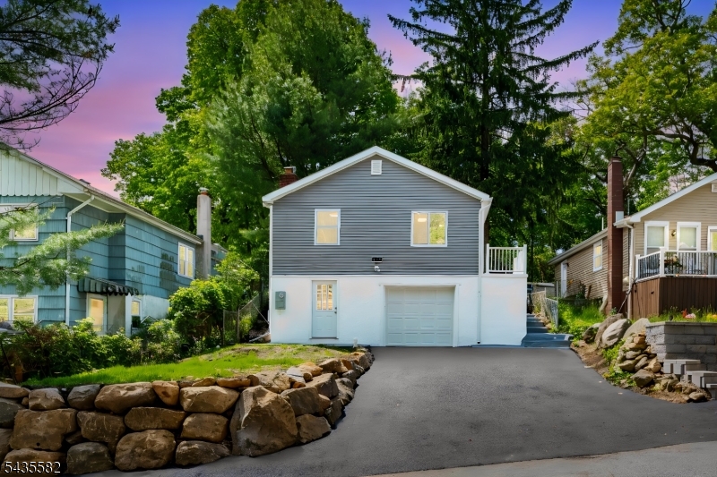 Welcome to this beautifully renovated 3-bedrooms, 1-bath home in the heart of the Lake Hopatcong community truly move-in ready and worry-free! The modern kitchen shines with brand-new granite countertops, complemented by a tastefully updated bathroom, all new windows, new flooring, fresh paint and fresh finishes in every room. Every major system has been new or updated: new siding, furnace (propane forced hot air), central AC, water heater, well holding tank and a brand new 2-bedroom septic system. All new appliances: including main level stackable washer and dryer and dishwasher! Updated electrical and plumbing. Gorgeously updated bathroom. The attached 1-car garage offers secure parking, generous bonus storage, and a separate utility room keeping your living spaces clean and clutter-free. Plus this home has a spacious blacktop driveway to park 3-4 cars. Out back, a secluded backyard provides the perfect private escape for relaxing, gardening, or entertaining. As a resident, you'll have the option to join Crescent Cove beach giving you access to beautiful Lake Hopatcong, NJ's largest lake. Boating, swimming, and lakeside living are right at your doorstep. Easy access to Route 206 and I-80. Love where you live!