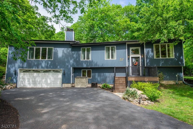This beautifully updated & expanded custom home offers style, exceptional space, a private setting just minutes from all Sparta has to offer. Eye catching curb appeal with a modern edge starts with Trex front steps and welcoming entry. Inside, an open and thoughtfully designed layout with updated finishes, abundant natural light, and spaces that feel warm and comfortable. The updated kitchen is designed for everyday living and entertaining with generous cabinetry, expansive workspace, double ovens, and seamless flow into the dining area. The incredible sunroom overlooking the peaceful, wooded .92-acre property is an inviting retreat in every season with access to the deck and property. Upstairs, a fully renovated hall bath serves two spacious secondary bedrooms, while the oversized primary suite feels like a private escape with vaulted ceilings, a cozy fireplace, walk-in closet, and an impressive ensuite bath. The lower level offers exceptional flexibility with full size windows bringing in natural light and space for a family room, home office, guest suite area, plus laundry and abundant storage. Oversized two-car garage and expanded driveway provide parking for everyone. Outside, enjoy a patio, fenced yard, firepit area, and beautiful wooded surroundings for privacy. Close to shops, restaurants, schools, and commuter routes. Newer well pump, septic pump, water softener, water heater. New gutters. *BEST AND FINAL OFFERS DUE WED 6/3 AT NOON
