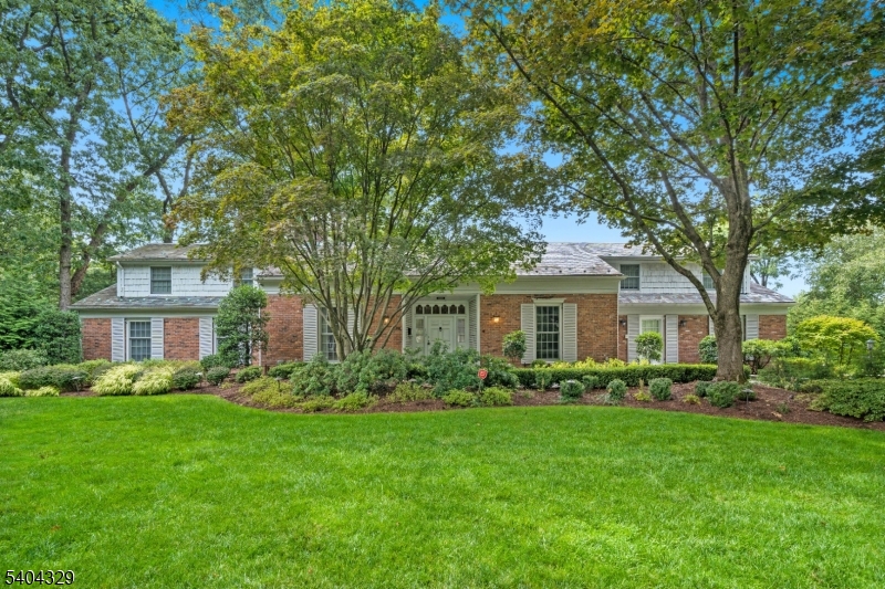 An elegant Upper Montclair custom home offering refined living and exceptional scale, set on a lushly landscaped three-quarter-acre property designed for both grand entertaining and everyday comfort. This impressive residence features four expansive three-room bedroom suites, including a luxurious first-floor primary suite, along with an additional ground-floor bedroom ideal for guests. Six beautifully updated full baths and two thoughtfully placed powder rooms provide effortless convenience throughout the home. Generous, light-filled rooms define the main level, including a large eat-in kitchen, richly appointed library, private office, formal living room with gas fireplace, and elegant dining room each designed with timeless proportions and seamless flow. The fully finished lower level is a destination of its own, featuring a spacious family room with fireplace, second kitchen, gym, bedroom, two full baths, and a temperature-controlled wine cellar perfect for recreation, relaxation, or hosting. Outdoors, the private grounds unfold into a resort-style retreat with manicured gardens, stone patios, a custom in-ground pool with cascading waterfall, and an inviting firepit, creating a tranquil setting for gatherings or quiet moments alike. A rare offering that blends classic architecture, modern amenities, and a truly exceptional lifestyle all close to Yantacaw Brook, Brookdale, Tuers Parks. Upper Montclair Village. restaurants + shops are close by.  .