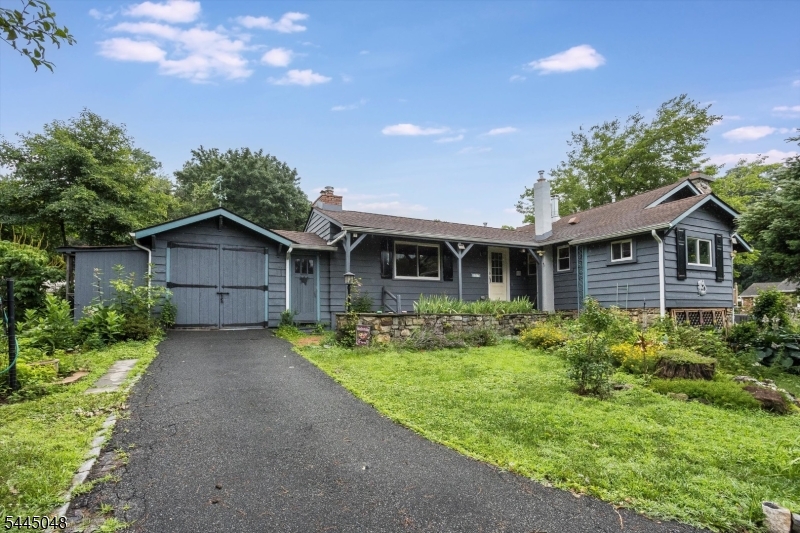 Welcome to this charming 2-Bedroom Ranch that captures the warmth & character of a lakeside cottage with the comfort of easy one-floor living. From the moment you arrive, you'll appreciate the inviting atmosphere & peaceful setting that makes this home truly special. Inside, you'll find two fireplaces that create a warm and cozy ambiance throughout the home. The Living Room offers a welcoming space to relax, while the stunning fieldstone fireplace in the Dining Area serves as a beautiful focal point, adding timeless character and rustic charm. The first-floor laundry provides everyday convenience, and the three-season room offers the perfect place to unwind while enjoying views of the yard. Step outside onto the deck and immerse yourself in a garden lover's paradise. The level yard is filled with colorful wildflowers, charming stepping-stone pathways, and thoughtfully designed garden spaces that invite you to slow down and enjoy nature. A dedicated gardener's shed and an additional storage shed provide plenty of room for tools, hobbies, and outdoor equipment. The attached one-car garage has been divided to create a workshop and storage area but can easily be converted back into a full garage if desired. Additional highlights include Natural Gas, Central Air, Public Water, and Public Sewer. Whether you're searching for your first home, downsizing, or looking for a peaceful retreat with the charm of an expanded cabin, this unique property is ready to welcome you home.