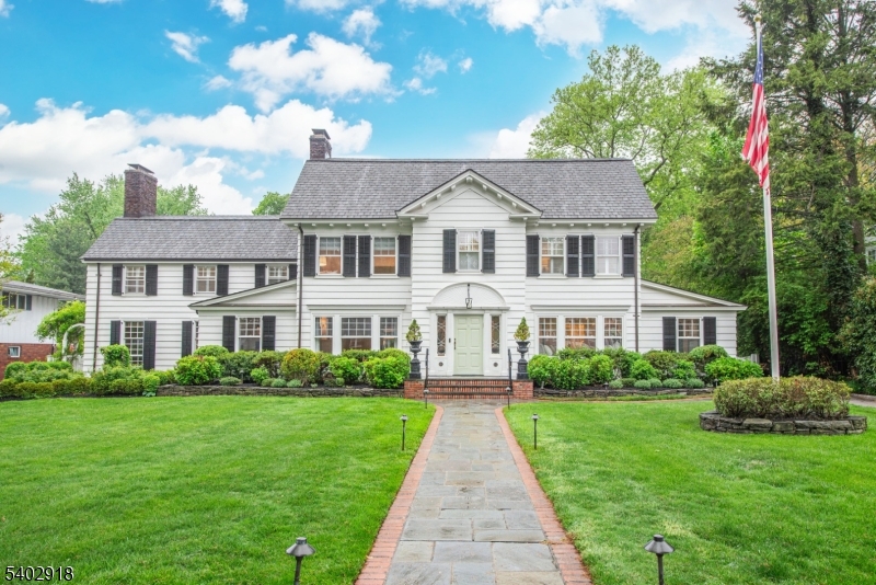 Welcome to one of Glen Ridge's most spectacular homes. This unique Colonial set on an acre of flat lawn (ideal for pool and tennis court) boasts 6,000 sq ft and is located steps away from coveted Glen Ridge schools, Montclair restaurants and commuter train stations. With 3 large living rooms, 6 bedrooms, 4 baths, and 2 powder rooms, the estate-like home combines lux living and elegant entertainment space. Chef-style kitchen with large island, Wolf double ovens, Wolf 6-burner gas range, Sub-Zero fridge, drink and wine fridge, butler pantry AND adjoining playroom/eating space. One light-drenched family room overlooks backyard and features custom millwork and massive ceilings. Another boasts mahogany walls and coffered ceilings, lodge-style gas FP, and magnificent bar w/ matching stools. The spectacular dining room features enclave shelving, custom window seat, and grand layout perfect for entertaining. Add'l 1st floor rooms include formal living room w/ FP, mudroom, powder room and office. Head up the newly carpeted front or back staircase to the second floor, featuring 5 spacious bedrooms, including primary suite w/ wood-burning FP and gorgeous marble bathroom w/ oversized tub, another bedroom w/ en-suite bath, and another w/ newly installed solarium/playroom. The 3rd floor hosts large bedroom, full bath and spacious laundry and storage room. Two finished basements provide versatile space: one w/ pool table and (fourth) FP; the other w/ playroom, wine cellar, and powder room.