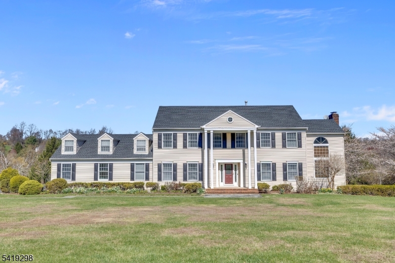 Nestled in the center of Chestnut Run, this center hall colonial is waiting for its new loving Owner to make it their own! Features include spacious rooms, 2-story paneled library with wood burning fireplace, large center island eat-in kitchen with skylight and sliders to deck overlooking expansive yard! Welcoming foyer leads to huge formal dining room with hardwood flooring and formal front to rear living room, also with hardwood flooring. family room has gas fireplace and wet bar, as well as sliders to deck. Laundry room and powder room complete the first floor. Second floor features primary suite with large walk-in closet, full bath with jetted tub and stall shower, 3 additional bedrooms and guest bath with double vanity. There are pull down stairs to attic storage, as well as a huge unfinished basement for storage or finishing. Other highlights include roof installed in 2020, Tesla charger in garage, newer exterior doors, columns and shutters, skylights with electronic shades and EV Tesla charger in garage and new garage side entrance door with extra room for workbench/storage. family Room TV remains; Excellent Chester schools, West Morris Mendham High School, short drive to Gladstone NJ Transit Train, quaint downtown Chester, local parks and trails makes this the perfect place to Call your next home!