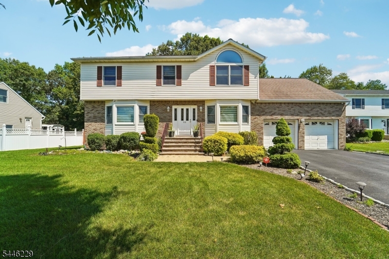 Beautifully maintained 4 Bedroom 2.5 Bathroom Center Colonial on a 0.37 acre lot in desirable Parsippany! This 2,541 sqft home offers an inviting layout with two spacious living areas, one featuring a cozy fireplace, plus a formal dining room ideal for entertaining. Updated eat in kitchen boasts cherry cabinetry, granite counters, tile backsplash & stainless steel appliances. Gleaming hardwood floors, crown molding & abundant natural light throughout the main level. Upstairs, the primary suite impresses with vaulted ceilings & an oversized arched window, plus a massive adjoining room offering flexible space for a home office, sitting room, or expansive walk-in closet. Three additional generously sized bedrooms complete the upper level. Finished basement adds valuable bonus living space. Enjoy outdoor living on the backside deck overlooking the expansive backyard. Attached 2 car garage with driveway parking fitting 4 or more cars! Zoned for Rockaway Meadow Elementary, Central Middle School & Parsippany High School. Prime location close to major highways & shopping. Don't miss this move in ready gem!
