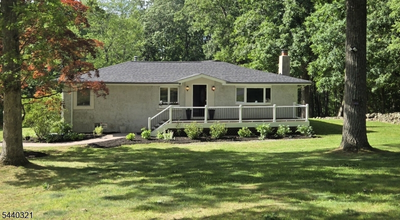 Tucked away at the end of a private street, this expansive ranch offers the perfect blend of privacy, space, and comfort on over 2 acres of scenic property. Designed for easy one-level living, the home features a functional layout and plenty of space for both everyday living and entertaining.The spacious kitchen opens to a brand-new Trex deck, creating the perfect setting for morning coffee, outdoor dining, or simply enjoying the peaceful surroundings. The primary suite also offers direct access to the deck, providing a private retreat where you can step outside and take in the beauty of the property.The full basement provides abundant space to grow into and endless possibilities to customize to your needs. Whether you envision a home office, gym, recreation room, workshop, or additional living space, this flexible area is ready for your personal touch.Adding even more versatility is a large outbuilding  with electric service, ideal for hobbyists, contractors, storage, a workshop, studio space, or future creative uses. Surrounded by nature and set off the road, the expansive grounds offer endless opportunities for recreation, gardening, or relaxation. Enjoy the privacy of country-style living while remaining conveniently close to shopping, dining, and commuter routes.