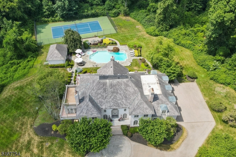 The search is over! This is the one! All brick Colonial custom home built by owner with everything you ever wanted, including a pool, pool house and tennis court! Ideally located on totally level 3.83 acres on a quiet cut de sac with great privacy. Once you walk into the grand 2-story entrance hall with 2 staircases reminiscent of Tara in Gone with the Wind, you will be captivated by the quality of the finishes! All rooms are of grand proportion to entertain. The kitchen is spectacular with granite countertops and top of the line Viking appliances. Stunning family room features gas fireplace with marble surround and 4 sets of arched French doors. Gorgeous dining room with gas fireplace, high ceilings and moldings. Incredible sunroom , office and mud room complete 1st level. 2nd level features the luxurious primary bedroom with tray ceiling, gas fireplace, walk-in closet & French door to terrace overlooking the pool, pool house & tennis court, & spa-like bath with marble floor & Jacuzzi. 4 more bedrooms & 4 more baths, a 2nd office & laundry room complete the 2nd level. Beautifully finished lower level with large recreation room with gas fireplace, media room with 8 leather chairs and large screen, powder room & cedar closet. Terrific amenities: stunning heated pool, pool house with shower & kitchen, new tennis court, French drains and 2 sump pumps, generator, 3 zone heat and air conditioning, 5 fireplaces and speakers for sound system in 1st level & Primary Suite
