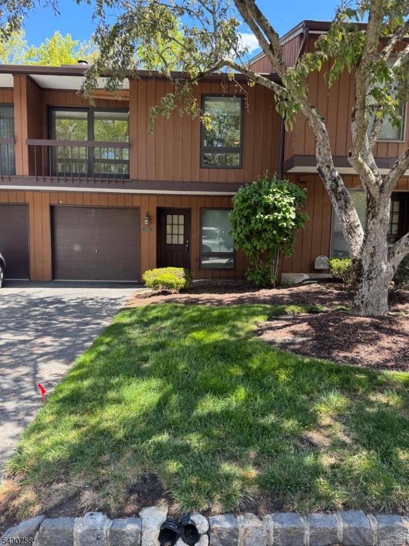 Welcome to desirable Overlook Village! This multilevel two-bedroom townhome offers an open-concept layout with spacious living and entertaining areas. The living room features sliders to a private balcony, while the family room boasts a cozy wood-burning fireplace and patio overlooking a peaceful wooded backyard. The primary bedroom includes its own private balcony and a full wall of closets. Additional highlights include a one-car garage and cul-de-sac location. Enjoy community amenities including a pool and tennis courts. This home is a must-see!