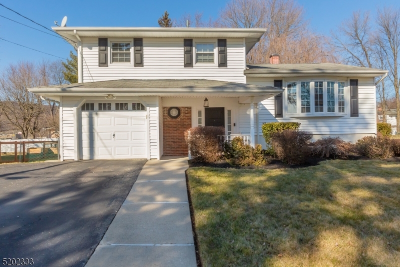 LOCATION, LOCATION, LOCATION!  RANKED AMONG THE BEST TOWNS TO LIVE IN WITH ONE OF THE BEST SCHOOL SYSTEMS IN NEW JERSEY!!! Welcome home to this FOUR bedroom, 1.5 Split Level!  Updated and tastefully decorated, this immaculate home is nestled in the desirable neighborhood of Clover Hill.  Light, bright and spacious room everywhere!  Step into this open foyer with 3/4 height wainscoting and chair rail.  Newer Therma Tru front door locking system, and a newer powder room located on the first floor.  Walk into a cozy Family Room with hardwood flooring and recessed lighting.  A three year old Anderson sliding door leads to a paver patio and EXPANSIVE PRIVATE yard!  This first floor level includes a flex use Playroom/Office/Bedroom with garage access!  Walk up to the second level to enjoy an open floor concept plan with Kitchen, Formal Dining Room and Living Room with TONS of natural sunlight beaming through the front picture bay window!  Third floor features two bedrooms and Master Bedroom.  Main third floor bathroom accessible from the hallway and Master Bedroom.  Featuring 6 panel doors throughout, TWO ZONE Central Air, 1 Zone Heat, ceiling fans and neutral paint! Thermal doors and windows!  Public utilities, natural gas, water, sewer...amenities and features GALORE!!!  Situated on a quiet street with impeccable curb appeal...DO NOT MISS OUT ON THIS HOME BECAUSE IT WON'T LAST LONG!!!  JUST MOVE IN AND ENJOY!!!