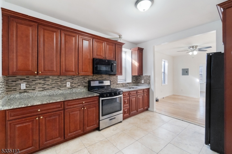 Beautifully Updated 2-Family Home! Renovated in 2021, both units offer identical layouts featuring 3 bedrooms and 1 bathroom, complemented by gleaming hardwood floors throughout. Designed for comfort and functionality, each unit has separate utilities, making it ideal for homeowners or investors. A newly installed fence enhances privacy, while the spacious backyard offers endless possibilities for outdoor enjoyment or potential expansion. Conveniently located near shopping, schools, and public transportation, this well-maintained property is a fantastic opportunity.