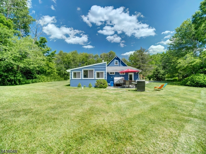 Situated on nearly an acre of beautifully maintained grounds, and located in a highly sought-after community with Blue Ribbon schools, this well cared for & updated home offers the perfect blend of comfort, style, and versatility. The open and inviting floor plan features a renovated kitchen with granite countertops, stainless steel appliances, pantry & quality finishes. The renovated bathroom's a big highlight for this gem. The spacious primary suite offers a renovated en-suite bath and walk-in closet, while the second bedroom is generously sized. A finished attic/second level provides valuable flex space ideal for a home office, playroom, guest area, fitness room, or hobby space. Additional highlights include a welcoming living room and dining area, convenient mudroom/laundry room, wood flooring, and a bright sunroom overlooking the backyard. Step outside to the patio and enjoy the expansive, park-like yard that provides a peaceful setting and backing directly to Palmer Park and Columbia Trail. The property is framed by mature trees and the setting feels like your own private retreat while remaining conveniently close to everyday amenities. Conveniently located near parks, schools, shopping, and commuting routes. A Must See!