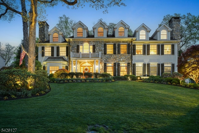 STUNNING PRIVATE OASIS in the Heart of Chatham, NJ. Exquisite 5-Bedroom, 4.1-Bath CUSTOM HOME set on a picturesque half-acre with sweeping views in a premier location. This exceptional residence showcases refined craftsmanship with archways, tray and coffered ceilings, transom windows, French doors, hardwood floors, abundance of custom cabinetry, wet bar, and more. A grand two-story foyer opens up to both elegant and casual living spaces, highlighted by three fireplaces. The custom curated kitchen by Leonardis Kitchens features Downsview cabinetry, premium appliances, granite countertops, and a sun-drenched breakfast area. The private, luxurious Primary Suite offers a serene sitting room with cathedral ceilings, fireplace, and a spa-like bathroom with soaking tub, steam shower, and dual walk-in closets. All thoughtfully designed, roomy bedrooms along with laundry room, are located on the second level. One bedroom has a charming Juliet Balcony, perfect to relax while admiring the view. The finished basement includes a recreation area, half bath, and additional laundry.  Enjoy a beautiful resort-style heated pool, expansive stone patio with outdoor fireplace and built in grill, and beautifully manicured grounds designed for seamless indoor-outdoor living and entertaining. Heated two-car oversized garage and Full house generator. Close to award-winning schools, lovely downtown, and direct NYC trains. This showcase of architectural detail and REFINED LIVING AWAITS YOU!