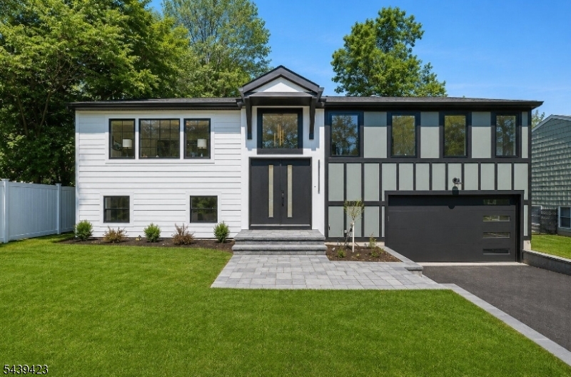 Stunning newly expanded and renovated Bi-Level offering approximately 3,200 square feet of beautifully designed living space with 5 bedrooms and 5 full baths. Completely rebuilt with exceptional attention to detail, this move-in-ready home features modern finishes, generous living areas, and a highly functional floor plan. The main level offers a beautifully appointed eat-in kitchen with stainless steel appliances, ample cabinetry, and direct access to an expansive deck overlooking the backyard. The open layout includes a spacious living room, convenient laundry area, and three bedrooms, including a luxurious primary suite with a large walk-in closet and private bath. A secondary bedroom also features its own en-suite bath.The ground level provides outstanding versatility with a spacious recreation area featuring sliding doors to a patio, two additional bedrooms, and two full baths, including a bedroom with a private en-suite bath ideal for guests, extended living, or a home office. Combining the feel of new construction with a desirable Livingston location close to top-rated schools, shopping, dining, and transportation, this exceptional home offers the perfect blend of comfort, style, and convenience.