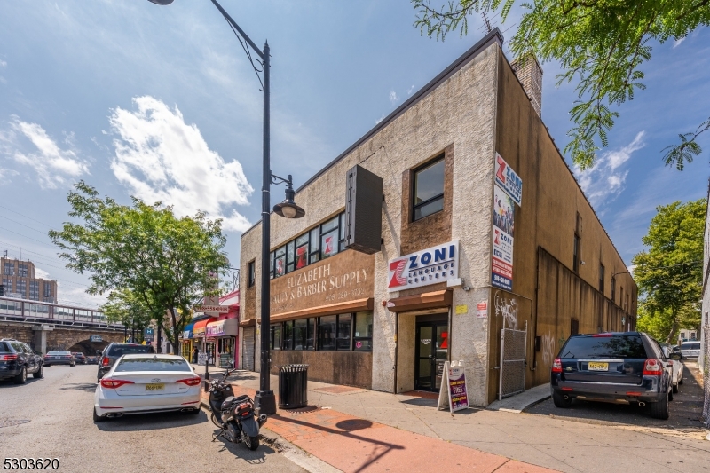 PRICE REDUCED... 11,400 sq. ft. Retail/Office Building for Sale on busy North Broad Street in Elizabeth Town Center consisting of two Lots, with separate Private Parking Lot. Includes 5,700 sq. ft. per floor, with a second floor Tenant paying $4,841/month plus Utilities.  First floor is a newly renovated large Open Space with two Private Offices & two new Bathrooms, for an Owner/Occupier or Tenant.  Rear 44 X 90 sq. ft. Private Parking Lot on Morris Avenue includes 7-9 Car Private, along with a side Driveway that occupies 4-5 Car parking, as well.  Also includes 2 Gas Heating Units and 3 CAC Units, Security Cameras, a new Roof in 2018 and newly renovated second floor in 2015.  Of Note: Owner would also consider leasing the first floor for $9,500/month ($20.00/sq. ft.) plus Utilities.  A half a block from the train station, this newly renovated building in Elizabeth Town Center with Private Parking, is a Great location for your Business, and is a "Must see" !