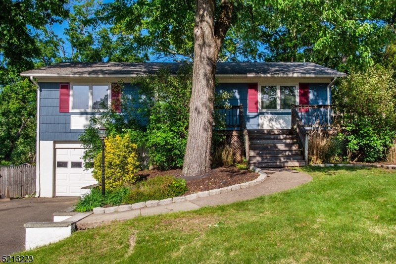 Beautiful single family home ideal for entertaining inside and out! Hardwood throughout with oversized living room and a dining room that flows into the deck that overlooks fenced in backyard! Eat-in kitchen includes smart refrigerator, dishwasher & gas stove. Basement boasts an exercise room (or office), spacious family room with dry bar, an additional full bath, garage access and laundry! This is the ideal home with central air, garage, natural gas and public utilities. Lots of storage space! Close to public transportation, shopping, grocery stores, highways and under 1 hour from NYC!