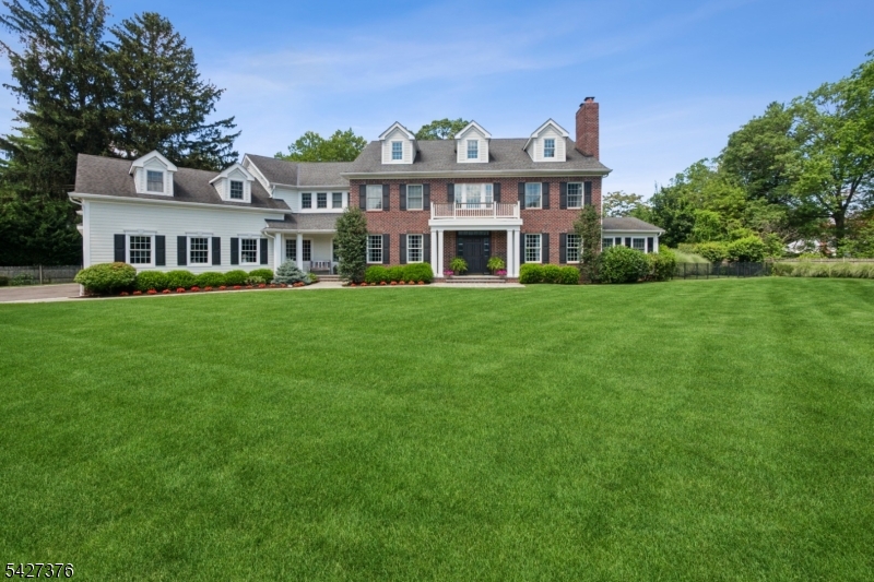 Nestled on a quiet Cul- de sac, this beautiful colonial home is the perfect blend of space & modern convenience. A dramatic two-story foyer, showcasing rich hardwood floors, bespoke millwork & a 1st.floor w/ impressive 12ft. ceilings.The sunlit living room is centered around a gas fireplace & the large formal dining room is flanked on both sides of the foyer.The heart of the home is the family room, a warm refined space, highlighted by a coffered ceiling, fireplace & custom-built ins. A thoughtfully appointed wine bar features extensive storage, refrigerator & beverage drawers.The gourmet kitchen is functional & striking featuring custom cabinetry, an oversized concrete center island, granite countertops, ss appliances all overlooking the private grounds. French doors from both the kitchen & family room open to an expansive terrace & pool, surrounded by lush specimen plantings & a tranquil koi pond- an idyllic backdrop for indoor-outdoor living a screened porch with a hot tub & tv offer a perfect year-round retreat.The well-designed 1st floor also includes a mud room with cubbies, full bath, powder room, laundry room & office.The 2nd level primary suite features a gas fireplace, custom dressing room,spa like bathroom & dry bar w/refrigerator. 4 additional bedrooms, three baths & a full gym complete this level.The 3rd floor offers additional versatile space. LL has a gym area, family room, bonus rooms & storage. Solar system.Tax records indicate a 5 BR home.Close to NYC train