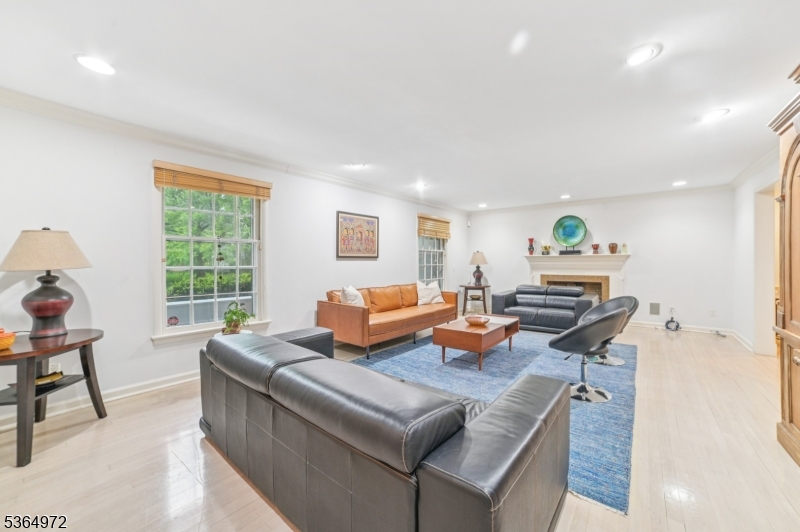 Beautifully maintained and expanded brick-front custom split located in the desirable Poets Section, just two blocks from Hartshorn School. This sun-filled gem offers large rooms, excellent flow, and sits on a lovingly maintained, level lot. The generous entry foyer with designer flooring leads into a bright and spacious layout. The large living room flows into the formal dinning room, breakfast area, and gourmet eat-in kitchen featuring granite countertops, stainless steel appliances, and large walk-in pantry. A warm and inviting den with a fireplace opens through French doors to a paver patio and a beautifully landscaped, private yard.  The second floor offers four bedrooms and a well maintained main bathroom. Each bedroom includes oversized closets, with one en suite bedroom that can also serve as a primary. The third floor features a spacious primary suite complete with dressing area, walk-in closet, and elegant bath. This lovingly cared for home is ready to welcome its next chapter. Harwood under carpets and whole house generator. Chimney Fireplace Flue As is with no known issues