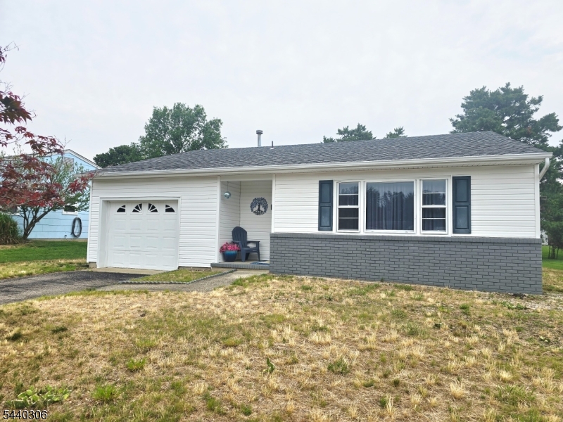 Beautifully renovated 2-bedroom home located in desirable adult community. This stunning home features a extended kitchen with white wood cabinetry, quartz countertops, a gorgeous backsplash and stainless-steel appliances - perfect for both everyday living and entertaining. Additional highlights include a beautifully updated full bathroom with a fully tiled walk-in shower. plus a convenient half bath for guests.  Elegant laminate flooring flows through living room and kitchen. A pocket door provides added privacy to the bedroom area. Major updates include a new roof 2019 and windows and siding 2020, offering peace of mind for years to come.  Just unpack and start to enjoy your next chapter!