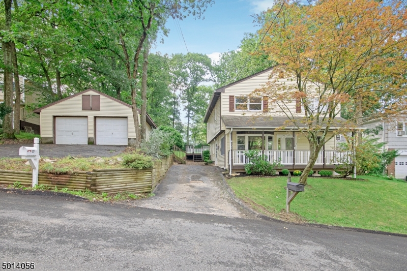 Wow!Come take a look! This updated colonial with open floor plan offers expansive familyroom with the perfect space for entertaining.Gorgeous floor to ceiling brick fireplace w/Wood burning insert . Freshly painted interior and newly installed carpet.Open flow from room to room, home offers plenty of Natural bright light, sliders to deck leading to large backyard for extended space and pleasure. Enjoy the relaxed tranquil vibes from your very own front Porch. Located on a quiet street with over sized 2 car detached, built-in storage and expanded driveway. Ideal for the hobby enthusiast, plenty of space for workshop and parking. Close to schools, shopping, and town center. Live in one of NJ biggest Lake Communities "Lk Hopatcong". You will not be disappointed in this exceptional find!