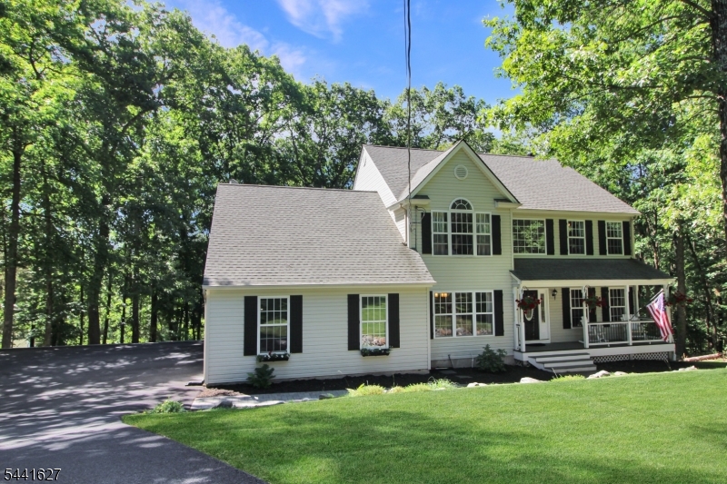 Welcome home to this beautifully updated Colonial nestled on a picturesque one-acre lot in  scenic Blairstown, NJ. Featuring gleaming hardwood floors and an open-concept layout, this home is designed for both comfortable everyday living and effortless entertaining. The modern kitchen showcases granite countertops, stainless steel appliances, and a custom tile backsplash, flowing seamlessly into the main living spaces. The first floor offers a formal dining room, spacious living room, inviting family room with a wood-burning fireplace, convenient laundry room, and sliding glass doors leading to a large rear deck overlooking the property. Upstairs, you'll find four generously sized bedrooms, including a spacious primary suite complete with a private bath and an enormous bonus room, perfect for a home office, sitting area, gym, or whatever suits your lifestyle. The mostly finished walkout basement provides additional living and recreational space, opening directly to the rear patio. An oversized driveway and attached garage offer ample room for multiple vehicles, storage, and recreational equipment. Ideally located near parks, dining, and outdoor recreation, with easy access to the Pocono Mountains and just over an hour from New York City, this exceptional property combines space, comfort, and convenience in a truly beautiful setting. Don't miss your opportunity to make this wonderful home yours!!