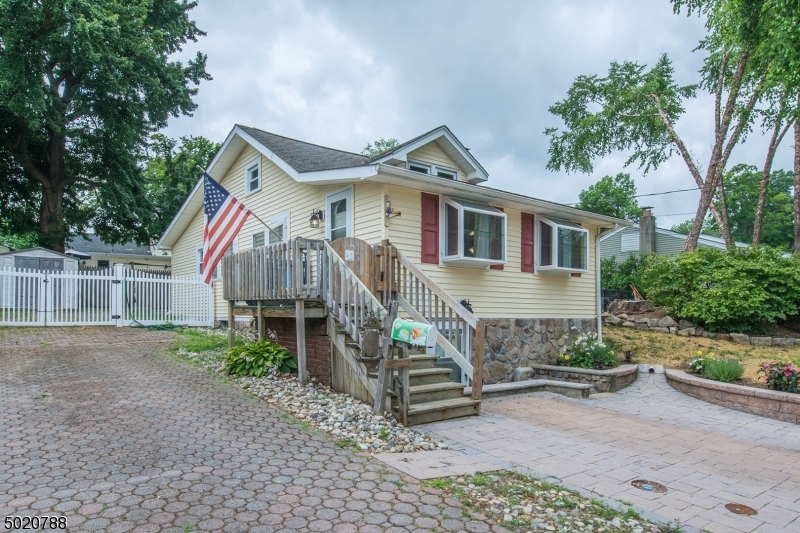 Indian Lake! Charming Ranch just mins from beach, boating, Clubhouse activities & more. Tons of Versatile Living Space! 1 floor living PLUS full, finished basement. Just a short walk to DWTN Denville & NYC Direct Train/Bus. Move in condition! Pride in ownership- same owner for over 30 yrs. 1st floor offers open layout -LR & Kitchen, 2 BDRMs, Full Bath & Office. Full, finished walk-out BSMT w/wet bar & WB Stove. Situated on a 1 way st. in a lovely neighborhood. Level, fenced in yard for play & relaxation. Tons of upgrades-newer roof, flooring, freshly painted, updated electrical, etc.. Just mins to DWTN Denville -a vibrant town w/ shopping, farmers markets, restaurants & lovely music that plays while you stroll down Broadway any hour of the day! Easy access to major hwys. This is your ticket into Denville!