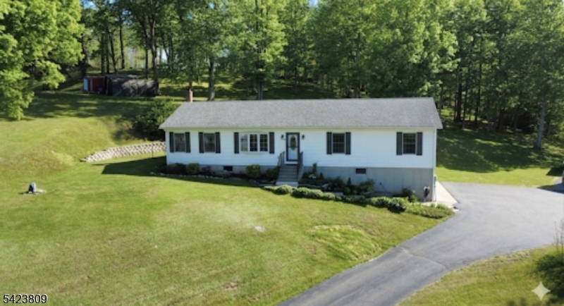 Move-in-ready ranch home set on almost 2 private acres in desirable White Township known for its low taxes and excellent elementary school. Finished lower level, workshop space, and oversized 2-car garage. This 1760 sq ft home has updated flooring throughout major living areas, stainless appliances, newer roof, water filtration system, and spacious finished basement ideal for recreation, hobbies, gym, or home office. Located along the Pequest river, not in a flood zone and minutes from Route 80 & 78. Surrounded by nature, enjoy the peaceful setting with functional layout and low-maintenance updates already completed.