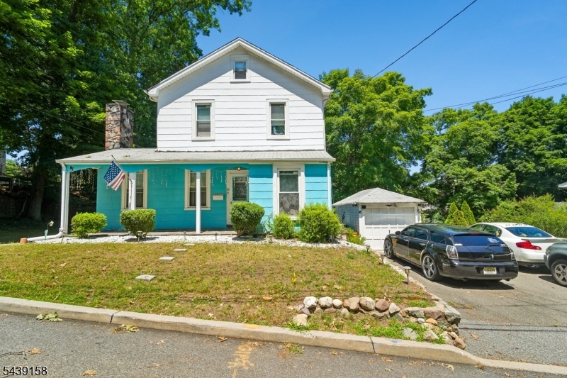 Welcome to this charming Colonial-style home nestled in a desirable residential neighborhood of North Haledon. Offering 7 spacious rooms, this well-maintained residence features 3 bedrooms, 1 full bath, and 1 half bath, providing a comfortable layout for everyday living. The first floor boasts a formal living room with a cozy wood-burning fireplace, a formal dining room perfect for entertaining, and an eat-in kitchen with ample space for casual dining. A small den offers the ideal setting for a home office, study, or flex space to fit your lifestyle. Wood flooring under carpet in the living room, dining room, and Half Bath. The 2nd Fl. 3 BED- 1 Full Bath. Additional features include a walk-up attic with excellent storage potential, an unfinished basement ready for your personal touch, and a detached one-car garage. The wide driveway accommodates up to two vehicles side by side for added convenience. Major updates include a hot water heater approximately 3 years old and a heating system approximately 2 years old, providing peace of mind for the new owner. This lovely home combines timeless Colonial character, practical living spaces, and a convenient location close to local amenities, schools, parks, and transportation.