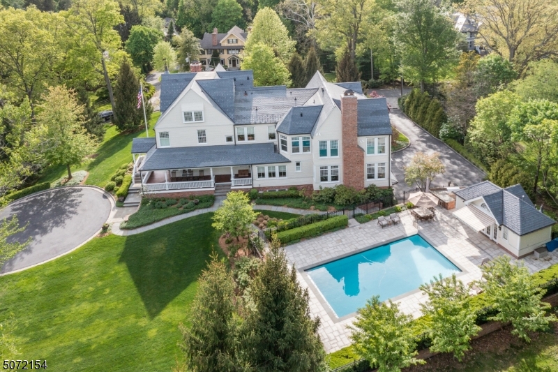 Spectacular custom home set atop a private knoll on over an acre of secluded grounds in the heart of Old Short Hills. Almost 9000 SqFt of new & completely renovated & enlarged living space in 2005-07. Extensive architectural and historical details, incl hi ceilings, mahogany covered porches, hdwd floors thruout, state of the art kitchen w/ marble counters, 2 d/w, sub zero refrigerator, double wolf ovens, 2 butler pantries. Huge family room w/ fireplace, coffered ceiling and wall of windows. Deluxe MBR suite w/ fabulous views, huge w/in closet and marble bath w/ steam shower. All bedrooms w/ en-suite bathrooms. LL w/ bedroom, rec room, kitchen, 3-car heated garage prewired for 2 EV charging stations, SavantPro smart home system, saltwater pool and pool house. Located in close proximity to train and schools.