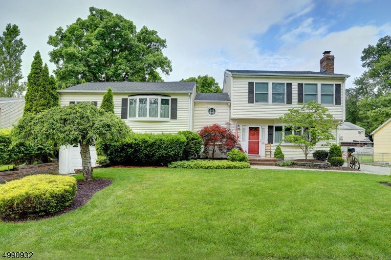 Expect to be amazed by this perfection!! 2 driveways, Professionally landscaped and manicured! Great size back yard with patio and deck, awning, Future pool and play area ,relaxation! Roof rip off 2 years ago!! Step into the Front door and gaze your eyes into the family room with true masonry brick fireplace with red oak and black walnut custom mantle. Plenty of recessed lights throughout. Hardwood floors in kitchen and family room with decorative inlay. Amazing kitchen Quaker-made wood cabinets , granite counters, casement windows, recessed lights,sliding glass doors to deck. Second floor has a large living room plus 2 bedrooms one with sliders out to a deck or use as office, Plus full bath and.  Third levelHas 3 bedrooms plus full bath. Laundry room.  Perfect for potential in law suite with privacy..