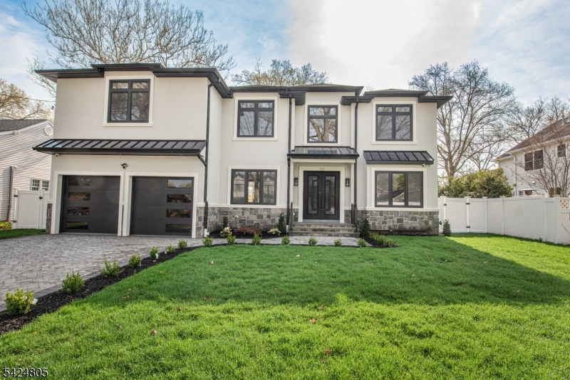 Introducing a beautifully crafted new construction in one of Paramus?s most sought-after neighborhoods. With 6 bedrooms, 5 full baths, and 1 half bath, this home delivers both scale and sophistication from the moment you arrive. A grand two-story foyer creates an impressive welcome, leading into a thoughtfully designed main level ideal for both everyday living and entertaining. The home features a formal living room and dining room, providing elegant spaces for hosting, while the layout flows seamlessly into a spacious family room highlighted by a dramatic two-story gas fireplace. The kitchen is complemented by a convenient wet bar and mudroom with direct access to the two-car garage, enhancing both function and flow. A first-floor bedroom with a full bath offers flexibility for guests or extended living. Upstairs, the primary suite serves as a private retreat, complete with dual walk-in closets and a spa-inspired bathroom designed for comfort and relaxation. Three additional bedrooms, each paired with full bathrooms, provide ample space and privacy, while a second-floor laundry room adds everyday convenience. The fully finished lower level is designed for lifestyle and entertainment, featuring a spacious rec room, private bedroom with full bath, kitchenette, and a dedicated movie theater. A utility room and additional storage complete the space. Outside, enjoy a fully fenced backyard with a stone patio perfect for outdoor gatherings.