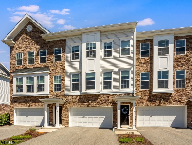 Experience luxury living in this stunning townhome, built in 2020, featuring 3 bedrooms and 3.5 baths.  Ideally situated near both Morris Plains and the Morristown train station, enjoy a seamless commute to NYC while savoring the tranquility of suburban life. With a wealth of amenities within walking distance including supermarkets, delightful dining options, and even a Starbucks this location truly offers the best of both worlds. Step inside to an open concept living and dining area that boasts a spacious layout, adorned with elegant hardwood floors throughout the main level. The well-equipped kitchen, complete with a stylish island, is perfect for casual gatherings and entertaining. Convenience is key with a laundry area located on the second floor, simplifying your daily routines. Each of the three bedrooms provides ample space, including a generous primary suite that features a custom walk-in closet, ensuring both comfort and versatility for your lifestyle. The ground level is designed for entertainment, featuring a roomy family room and a full bathroom that flows effortlessly into a private backyard. Enjoy the added benefits of a 2-car garage, complete with extra storage and a wide driveway for additional parking options. Don't miss this opportunity to own a modern townhome where luxury meets convenience!  The Collection In Morristown has the added benefit of a 25 year Pilot tax which provides for uniquely low property taxes.