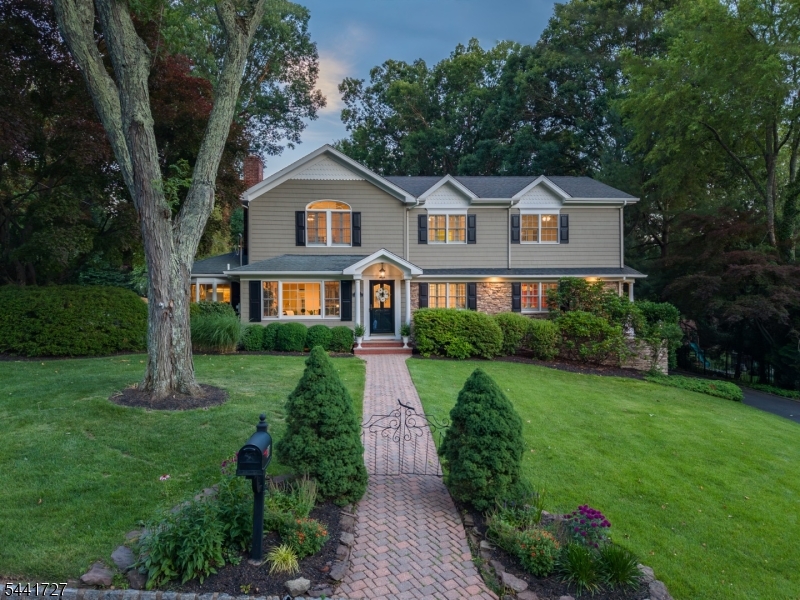 RESORT-STYLE LIVING ON ONE OF CHATHAM'S MOST COVETED STREETS! Welcome to 38 Hilltop Terrace, a private shaded street w/ a neighborly vibe that's truly in the center of it all, just minutes to highly ranked schools & vibrant downtowns of Chatham, Summit & New Providence. The beautiful property immediately grabs your eye with its pristine exterior, professional landscaping & stacked stone walls & beds. Hidden 2-car Garage tucked into a charming fenced-in backyard boasts multiple patios, a grill deck, landscape lighting, lush shade trees & beautiful grass yard that will surely be an oasis throughout the seasons. Inside, there are expansive spaces, beautiful millwork, gleaming hardwood floors, windows flooded w/ light & rooms to suit every modern-day need, including an ensuite bedroom & office with private patio on the main floor. Living Room has stacked stone wood-burning fireplace & leads into bright Breakfast Room open to a Kitchen sure to delight every home chef with custom inset cabinetry, granite countertops & high-end SS appliances. Step into the vaulted-ceiling Family Room facing the backyard & imagine effortless indoor/outdoor entertaining. Upstairs entices with massive Primary Suite with soaring ceilings, gas fireplace, great closet space & spa-like Bath with incredible shower & Jacuzzi tub. Two more large Bedrooms, Full Bath & Laundry complete this level. Lower has tons of room for play, TV, exercise & more plus Half Bath & 2nd Laundry! You must see this for yourself!